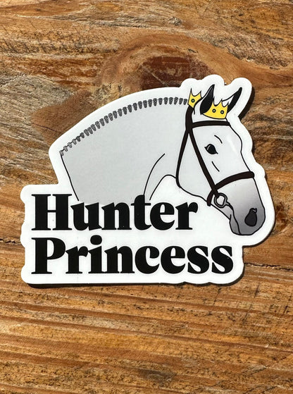 Vinyl sticker- Grey horse with hunter braids and snaffle bridle wearing a crown. Text under horse reads "hunter princess"